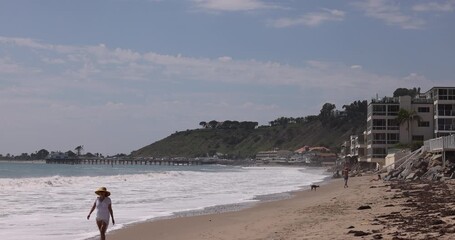 Wall Mural - Afternoon waves wash up on to Carbon Beach in Malibu, California, USA.