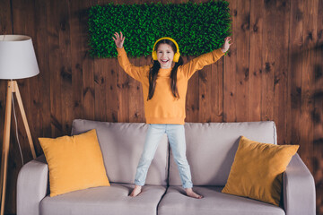 Canvas Print - Full size photo of cute small girl headphones dance stand sofa dressed orange outfit cozy day light home interior living room