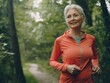 © Olya Ivanova - Elderly woman jogging in autumn park, close-up, realistic photo, banner, backgroun