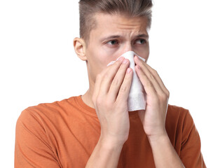 Wall Mural - Young man with tissue suffering from sinusitis on white background