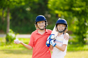 Wall Mural - Kids playing cricket in summer park