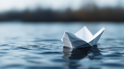 A white paper boat is seen floating serenely on the water, capturing the tranquility and simplicity of a peaceful day. The calm water reflects the boat perfectly.