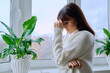 © Valerii Honcharuk - Middle aged woman experiencing stress depression mental pain, at home near window
