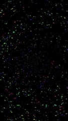 Wall Mural - vertical rainbow confetti spew on black 4k loop features multicolored particles pouring upward out o