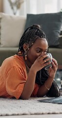 Poster - Woman, drinking coffee and laptop on floor with reading email, research or social media in living room. Black person, computer pc or tea for relax, streaming internet or networking with peace in home