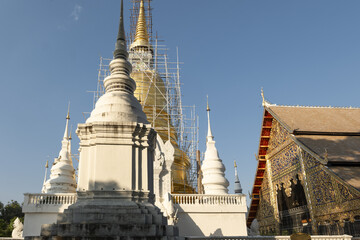 Wall Mural - Whitewashed chedi of Wat Suan Dok covered with bamboo scaffolding in Chiang Mai, Thailand