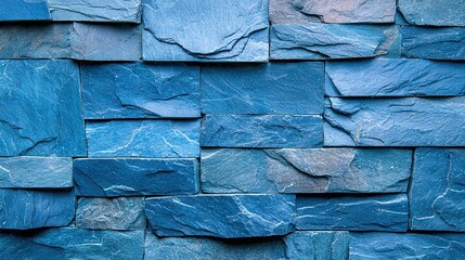   A close-up of a blue stone wall with clocks on both sides