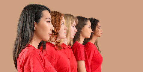 Wall Mural - Beautiful young women on beige background. Women history month