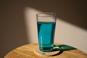 close-up image of a glass of water and methylene blue