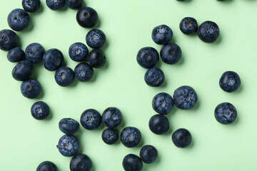 Wall Mural - Sweet fresh blueberries on green background