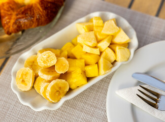 Wall Mural - Healthy food - sliced bananas and pineapples on a plate. High quality photo