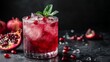 © Nijat - Deculent pomegranate mixed drink against a dark backdrop