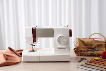 Wall Mural - Modern sewing machine with fabric and tailor's supplies on wooden table