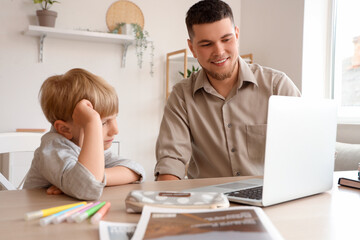 Poster - Cute boy with his father doing homework at home