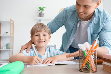 Sticker - Cute boy with his father doing homework at home