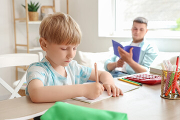 Poster - Cute boy taking dictation by his father in room