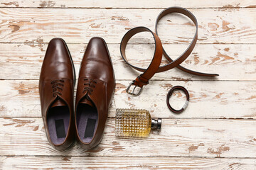 Wall Mural - Male shoes with perfume bottle and accessories on white wooden background