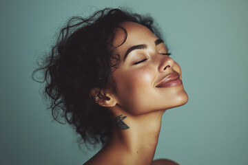 A close up of a woman's face with tattoos and her eyes closed