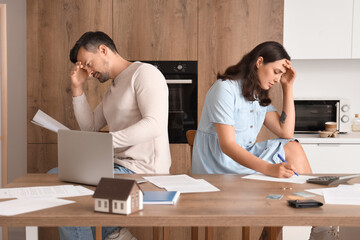 Poster - Young couple quarreling at home. Bankruptcy concept