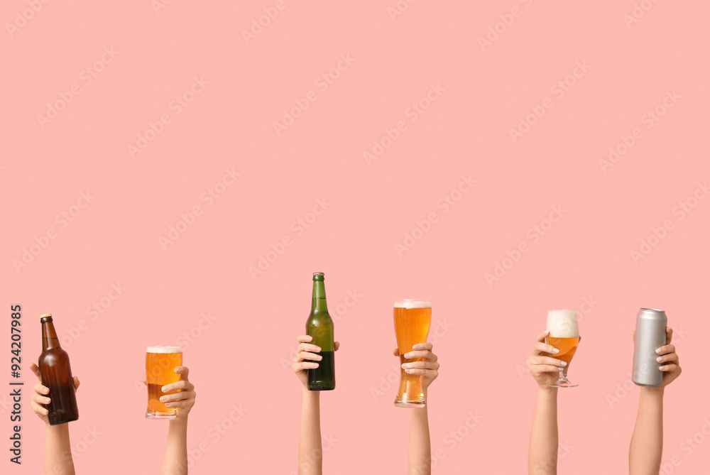 Female hands with fresh beer in pints, can and bottles on pink background