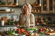© shustrilka - happy smiling middle-aged woman with gray hair is cooking in a cozy kitchen, surrounded by fresh vegetables, various kitchen utensils, process of preparing a healthy meal.