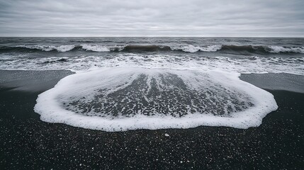 Poster -   A water body resting on a sandy seashore with an abundant amount of white froth on the shoreline