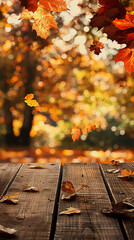 Canvas Print - wooden table with orange leaves and blurred autumn background