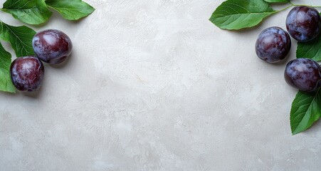 Wall Mural - fresh plums with green leaves on a light background