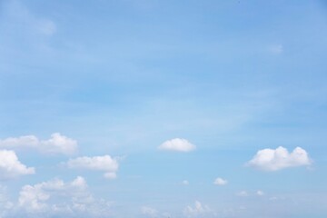 Wall Mural - blue sky background and white clouds soft focus, and copy space horizontal shape.