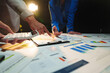© Phimwilai - Group of business people brainstorming in analytical plan meeting Calculate the numbers obtained from the graph. Financial growth chart. Marketing. Concept of business success statistics.