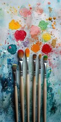 Colorful paintbrushes on a vibrant palette with paint.