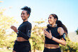 © peopleimages.com - Friends, women and exercise with running at park in happiness for workout and jog in Atlanta. People, runner and smile or confident with fitness for health, wellness and self care on race in forest