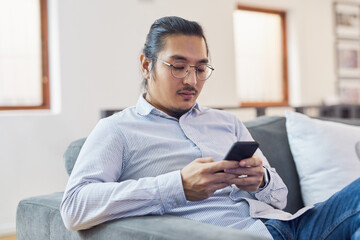 Poster - Businessman, online and relax with smartphone in office for research story, monitor news updates and check information. Male journalist, sofa and internet for communication with source and contact.