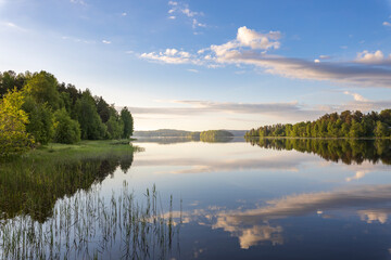 Wall Mural - a calm lake with a cloudy sky in the background