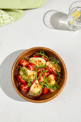 Canvas Print - Crispy Fried Halloumi Cheese with Juicy Tomatoes and Fresh Arugula in a Wooden Bowl