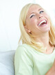 © ReeseBuyout1/peopleimages.com - Happy, woman and laughing on sofa in home for funny joke, humor and silly in living room on weekend. Female person, smile and thinking in house with positivity for peace, comedy and goofy memory