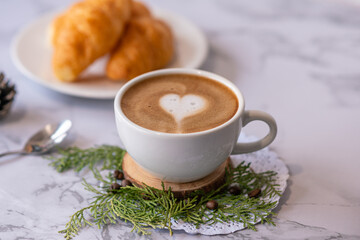 coffee heart pattern with croissant