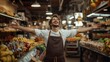 © Winter KD - People working in the supermarket A handsome young man wearing an apron and shirt is standing proudly and happily.