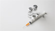 © 소연 박 - Two empty vials lying on a white background, with an empty syringe lying next to them