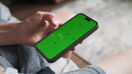 Poster - close up of teenager using mobile phone with green screen, surfing internet or scrolling social medi
