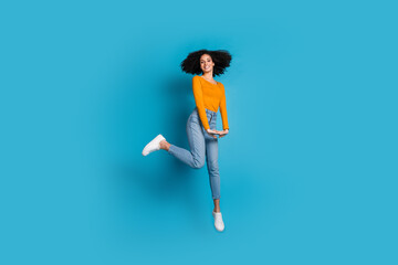 Canvas Print - Full body photo of attractive young woman jump sweet girlish posing dressed stylish yellow clothes isolated on blue color background