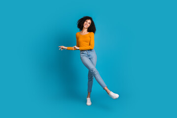 Sticker - Full body photo of attractive young woman dancing have fun dressed stylish yellow clothes isolated on blue color background