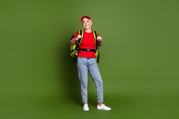 Poster - Full length photo of pensioner lady delivery service employee thermo bag dressed red uniform workwear isolated on khaki color background