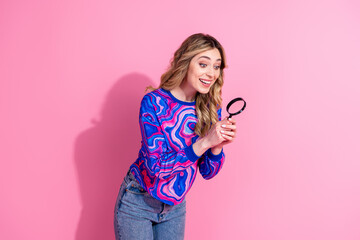 Wall Mural - Portrait photo of funny curious lady dyed hair wearing colorful shirt enlarge objects with magnifier isolated on pink color background