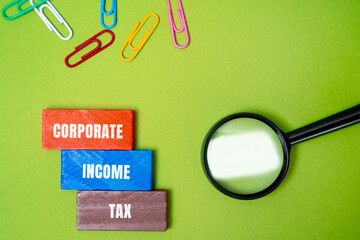 Corporate income tax concept. Taxes imposed by governments on the profits generated by companies. Inscription on the blocks. business and finance