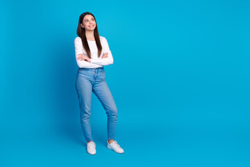 Canvas Print - Full length photo of lovely teen lady crossed hands look empty space dressed stylish white garment isolated on blue color background