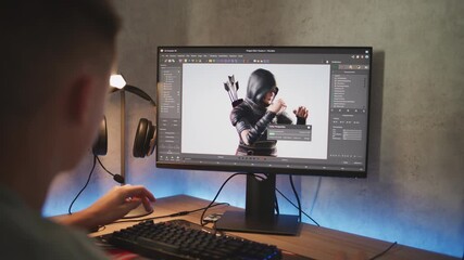 Fototapete - Caucasian teenager rendering model of game character on PC. Interface of professional 3D modeling program. Young 3D designer working on freelance project on computer at home. Game development concept.