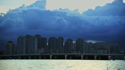 Canvas Print - Time lapse of dark clouds over the seaside city