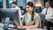 © N7 - An Indian woman working on a computer, assisting customers via online chat or email.