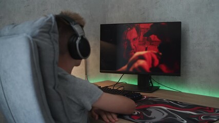 Poster - caucasian teenager in headphones watches online thriller or action film on personal computer while s